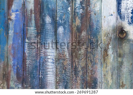 Old painted wooden door, in blue tone