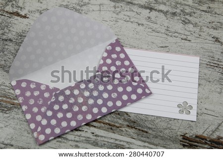 Handmade envelope and blank letter, in a paper with dots