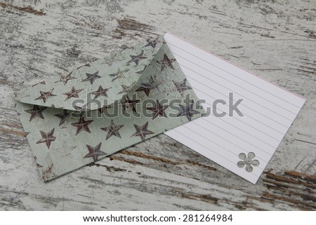 Handmade envelope and blank letter, in a paper with stars