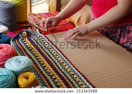 Woman hands weaving a handmade carpet