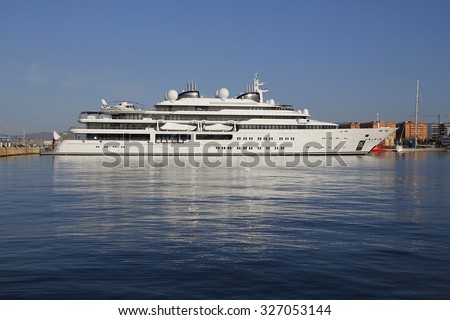 Luxury yacht with private helicopter, moored on harbor