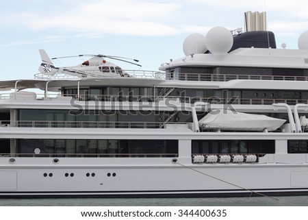 Luxury yacht with helicopter, moored on harbor