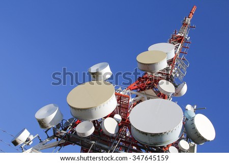 Telecommunications tower against blue sky