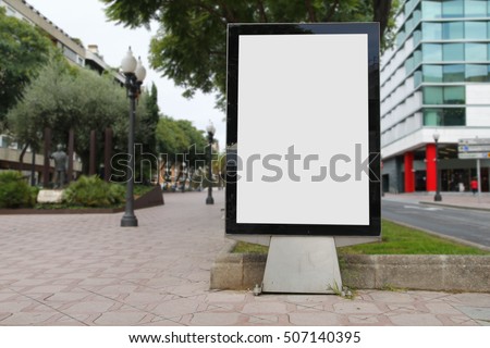Blank billboard mockup in the street, with blurred background