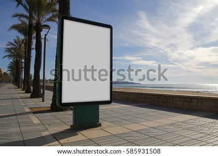 Blank billboard mock up in a sidewalk, next to the sea