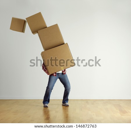 Man Carrying Stacked Boxes On Moving Day