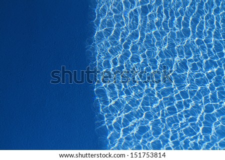 Shadow and light in swimming pool blue water