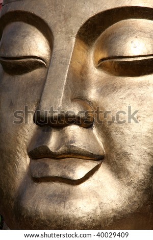 Closeup of golden Buddha face