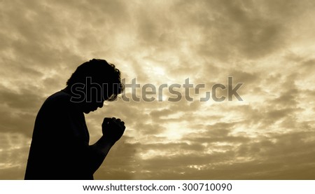 Silhouette of man praying