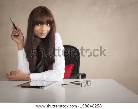 Young indian business executive gesturing with illustrator pen