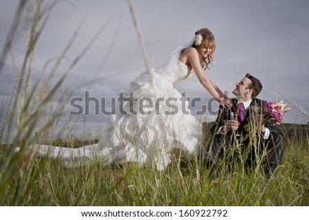 Young attractive caucasian couple relaxing together outdoors in long grass