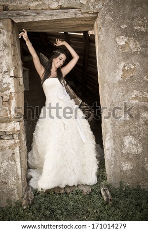 Young attractive caucasian woman dancing in old building door frame