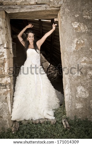 Young attractive caucasian woman dancing in old building door frame