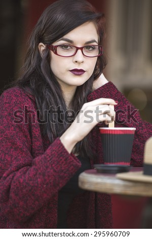 young beautiful traveler enjoying a coffee at street cafe