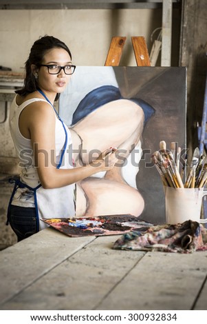 Young attractive artist working in art studio