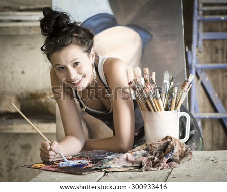 Young attractive artist working in art studio