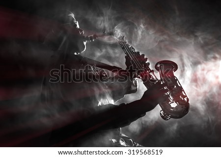 African jazz musician playing the saxophone. Black and white with color flare