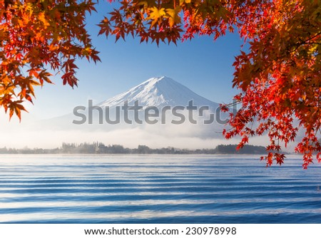 Mountain Fuji and Kawaguchiko lake with morning fog and maple leaves in autumn season