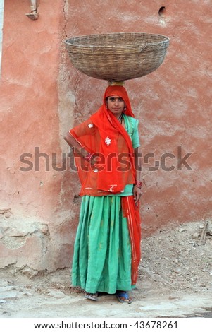 stock-photo-indian-lady-carrying-basket-from-rajasthan-43678261.jpg