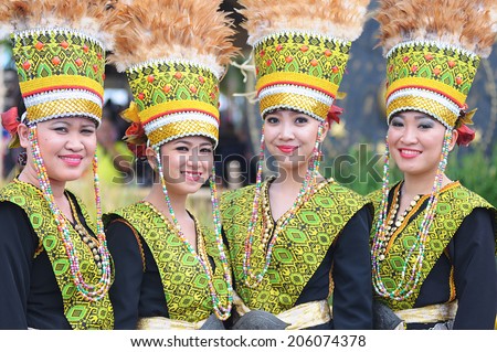 Kota Kinabalu, Sabah Malaysia. May 31, 2014 : Ladies from Dusun ethnic wearing colourful traditional costume poses for the camera during the Harvest Festival celeberation in Kota Kinabalu, Sabah.