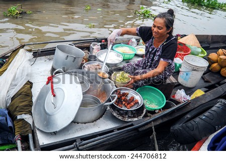 Cai Rang, Can Tho Vietnam. June 14, 2014 : Unidentified lady hawker preparing noodle soup at floating market Mekong River, Cai Rang Can Tho Vietnam on June 14, 2014.