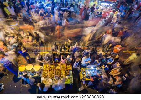 Kota Kinabalu Sabah Malaysia.February 17, 2015: Crowded people in motion at night market on February 17, 2015 in Kota Kinabalu, Sabah.Night market is popular spot among Malaysian to buy bargain items.