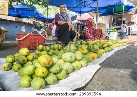 Tuaran Sabah Malaysia - June 23, 2015 : Unidentified woman selling mango at traditional marketplace called Tamu on June 23, 2015 in Tuaran Sabah.