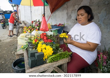 Mactan Cebu Phillipines - May 24, 2015:Unidentified streets florist selling flower outside graveyard complex in Mactan island.