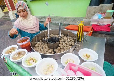 Kuching Sarawak Malaysia-September 3, 2015:Unidentified muslim street food vendor preparing local dish called Bakso at Kuching Waterfront esplanade on September 3, 2015.