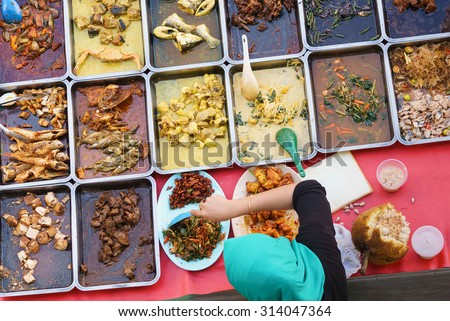 Variety of delicious Malaysian home cooked dishes sold at street market stall in Kota Kinabalu Sabah from top angle view.