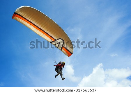 Ranau Sabah Malaysia - May 18, 2014:Unidentified person taking off with a paraglider at Sonsoluyon spot.This paragliding spot is popular with scenic view with Mount Kinabalu as an major attraction.