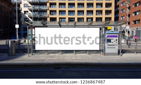 Blank Billboard template on a tram stop in a large modern city.