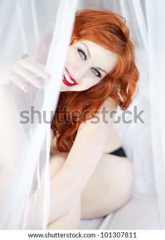 Beautiful woman in bed with mosquito net