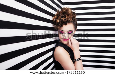 Portrait of beautiful young woman with professional party make up false eyelashes