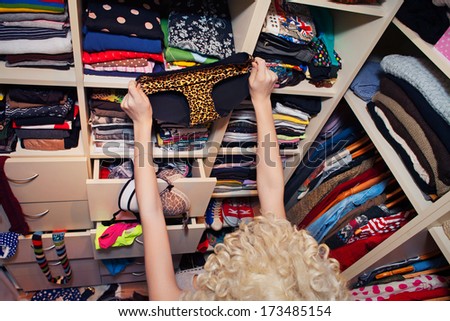 Getting dressed concept woman  in walk in closet choosing underwear