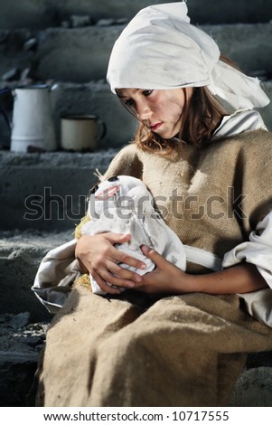 Sad poor girl wearing dirty vintage clothes, holding a smiling doll, similar available in my portfolio