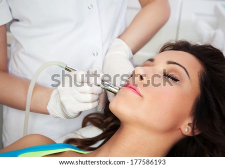 Woman getting laser face treatment in medical spa center, skin rejuvenation concept