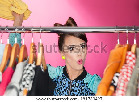 Time for refreshing wardrobe young attractive surprised woman searching for clothing in a closet