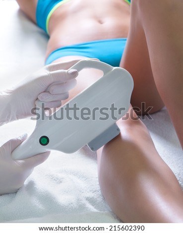Woman getting laser treatment in medical spa center, permanent hair removal concept