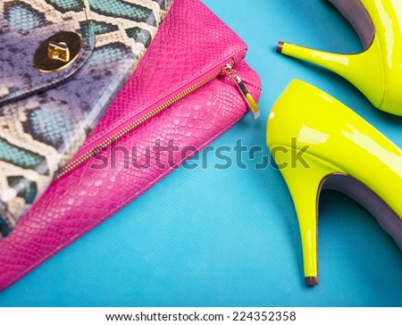 Neon high heels, dress and snakeskin print bag, woman fashion concept
