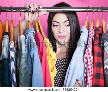 Time to refresh wardrobe young attractive surprised woman searching for clothing in a closet