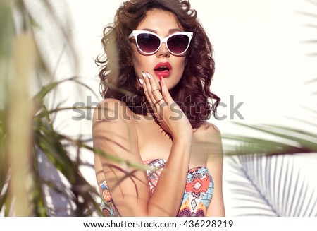Summer style portrait of young attractive surprised woman wearing sunglasses. Tropical summer holiday fashion beauty  concept