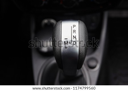 Close-up on automatic transmission lever in modern car. Car interior details. Transmission shift.