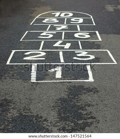 The game hopscotch for children in yard on asphalt