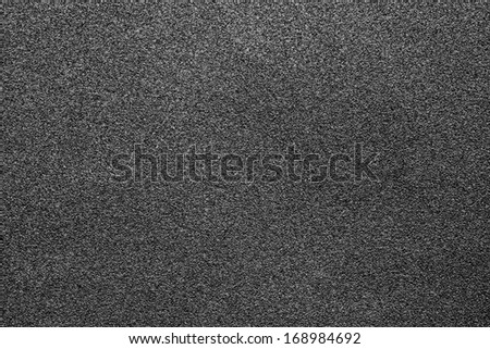 Fine-grained texture of a black abrasive material for wallpaper and for abstract backgrounds