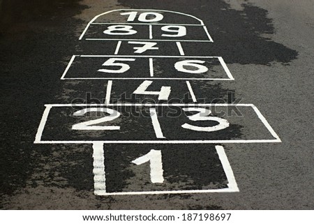 The game hopscotch for children in yard on asphalt