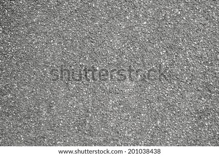 rough granular texture of an old asphalt surface for abstract gray backgrounds with impregnations