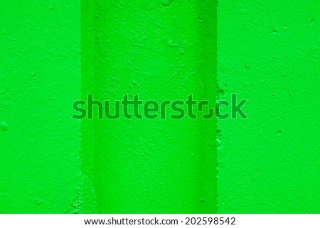 abstract relief of a hollow and ledges on a concrete wall for textural backgrounds of bright green color