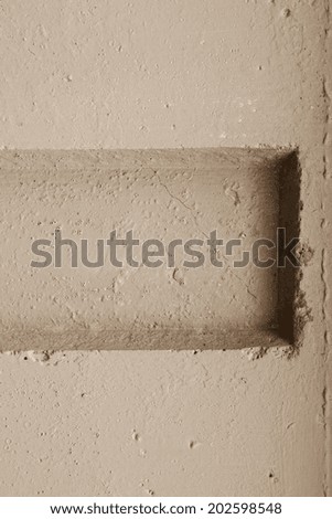 abstract relief of a hollow and ledges on a concrete wall for textural backgrounds of beige color