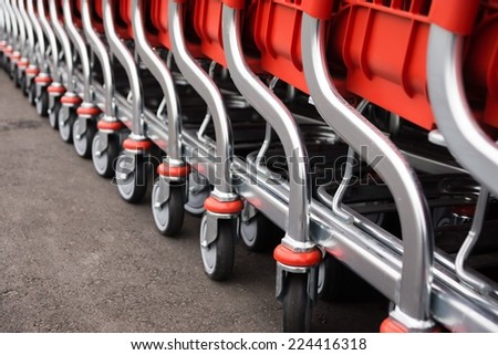 metal parts of red baskets-carts for warehousing of food and household goods upon purchase in shops and in markets